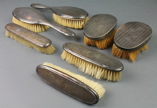 A silver backed engine turned 5 piece brush set, 1 other 