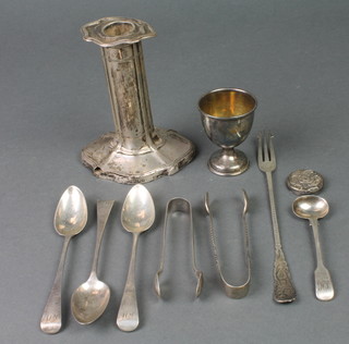 A silver egg cup, Birmingham 1932, minor flatware and a silver filled candlestick 