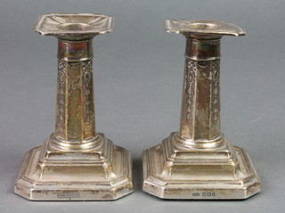 A pair of Edwardian silver dwarf candlesticks on stepped bases, Sheffield 1910