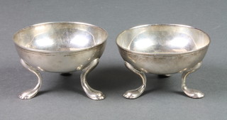 A pair of Georgian circular silver table salts on hoof feet, Dublin, rubbed marks, 192 grams