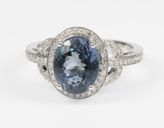 A 14ct white gold tanzanite and diamond ring, the centre stone approx 3 1/2ct, the open mount set with approx. 0.5ct of diamonds, size M 1/2