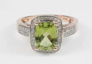 A 14ct yellow gold peridot and diamond cocktail ring, the centre stone approx 3.2ct  surrounded approx 0.75ct of diamonds, size M
