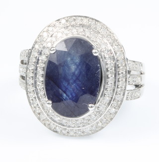 A 14ct white gold sapphire and diamond ring, the centre stone approx 5.6ct surrounded by 0.7ct of diamonds, size M 1/2
