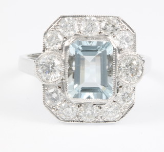 An 18ct white gold Art Deco style aquamarine and diamond ring, the rectangular cut stone approx. 1.80ct surrounded by 12 brilliant cut diamonds approx. 1.35ct, size Q