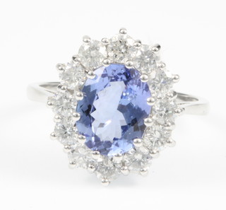 An 18ct white gold tanzanite and diamond dress ring, the centre stone approx. 2.35ct surrounded by 12 brililant cut diamonds approx. 1.30ct, size P