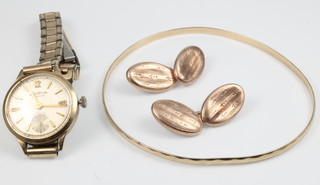 A 9ct gold bangle and a pair of ditto cufflinks, 6 grams, a lady's 9ct gold wristwatch on a gilt bracelet 