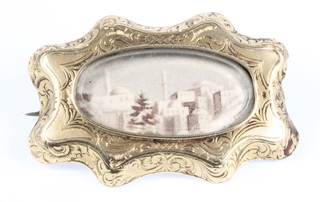 An Indian gold brooch decorated with a print of a townscape 1.25" 