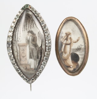 2 early 19th Century gilt oval mourning brooches with painted decoration, 1 set with paste stones