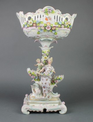 A German porcelain centrepiece the bowl supported by a figure and angel on a Rococo base 18" 