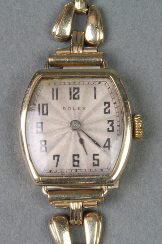 A lady's 9ct gold Rolex tonneau shaped wristwatch on a plated bracelet 