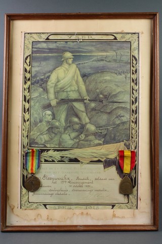 A French First World War Victory medal together with a Belgian commemorative medal, mounted on a illuminated address, framed