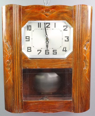 An Art Deco wall clock with 9" lozenge shaped silvered dial contained in an oak case 