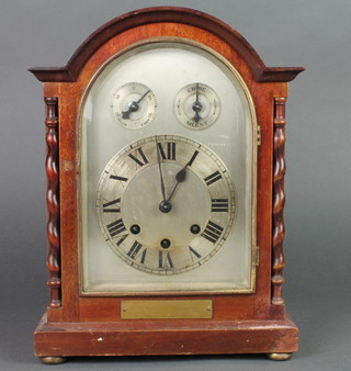 A chiming bracket clock with arched silvered dial and Roman numerals, having a slow fast dial and chime/silent dial, contained in an arched mahogany case 