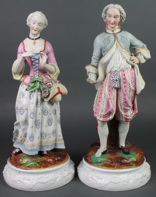 A pair of 19th Century Continental bisque figures of a lady and gentleman on raised bases 17" 