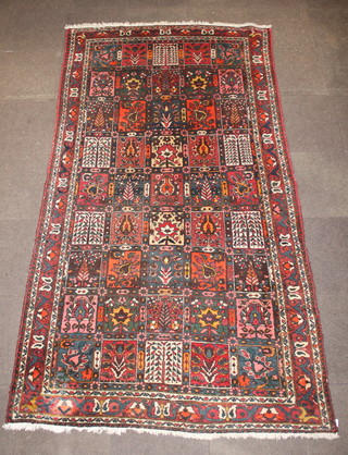 A Persian Bakhtiar decorated rectangles within a border  120" x 64" 