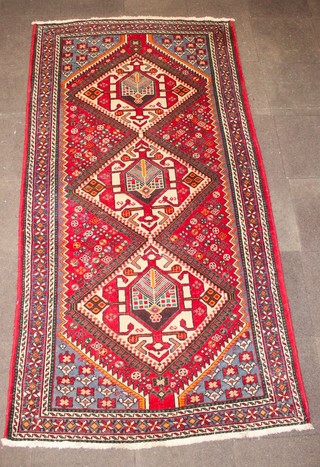 A Caucasian style rug with 3 diamonds to the centre 117" x 61" 