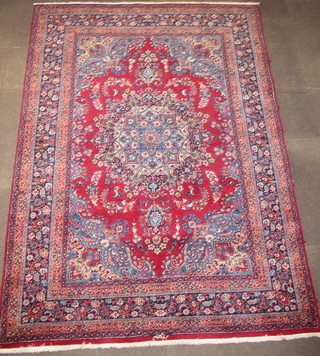 A red and blue ground Persian carpet with central medallion, bears signature 133" x 97" 