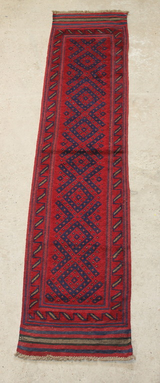 An Afghan red ground runner with 7 octagons to the centre 99" x 22 