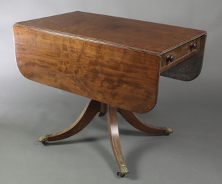 A 19th Century mahogany pedestal Pembroke table, fitted a frieze drawer and raised on turned column and tripod base, brass claw caps and castors 28"h x 36"w x 22" when closed x 46" when fully extended