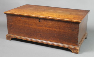 An 18th/19th Century rectangular oak coffer with hinged lid, the interior fitted a candle box with iron lock, raised on bracket feet 30 1/2"h x 35"w x 20"d
