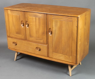 An Ercol light elm sideboard fitted a cupboard above 1 long drawer flanked by cupboards raised on turned supports 32"h x 45"w x 19"d 