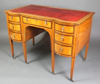 An Edwardian inlaid and crossbanded satinwood writing table with red inset writing surface above 1 long and 6 short drawers, raised on 6 tapered supports ending in brass caps and casters 30"h x 42"w x 25"d  