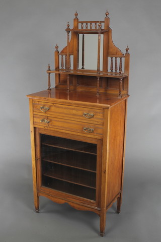 A Victorian walnut music cabinet, the raised back fitted a mirror above 2 short drawers, the base enclosed by a glazed panelled door 58"h x 24"w x 14"d 