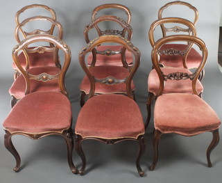 A harlequin set of 9 Victorian mahogany carved and pierced balloon back dining chairs comprising 3 sets of 3, all raised on cabriole supports 