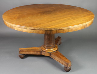 A circular William IV rosewood snap top breakfast table, raised on a turned column and with triform base, raised on turned and reeded bun feet 28"h x 46" diam. 