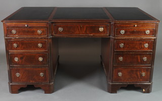 An inverted breakfront mahogany partners desk fitted brushing slides above 1 long and 3 short drawers, raised on bracket feet 31"h x 59"w x 36"d 