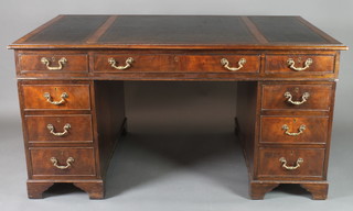A mahogany kneehole pedestal desk with inset writing surface above 1 long and 8 short drawers, raised on bracket feet 30"h x 59"w x 38"d 