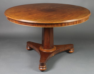 A circular William IV mahogany breakfast table raised on a chamfered column with triform base 27 1/2"h x 45" diam.
