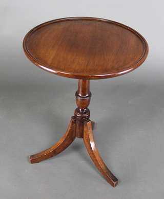 A circular Georgian style mahogany wine table raised on a pillar and tripod base 21"h x 16" diam. 