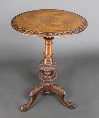 A Victorian inlaid figured walnut occasional table with carved border, raised on a associated pillar and tripod base 29"h x 19 1/2"