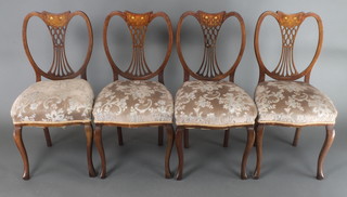 A set of 4 Edwardian inlaid mahogany dining chairs with heart shaped slat backs and upholstered seats, raised on cabriole supports