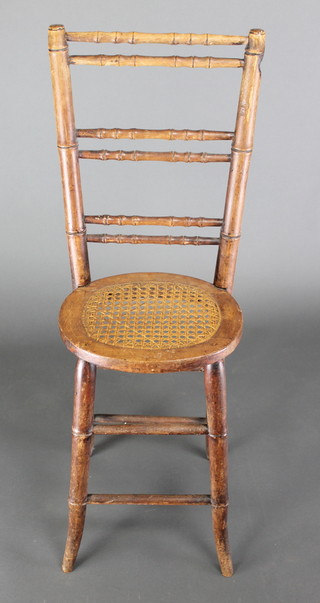 A Regency bamboo ladder back childs training chair with woven rush seat