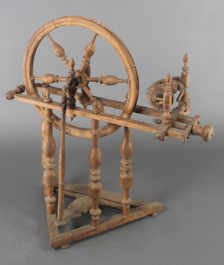 An 18th/19th Century yew spinning wheel with baluster turnings 