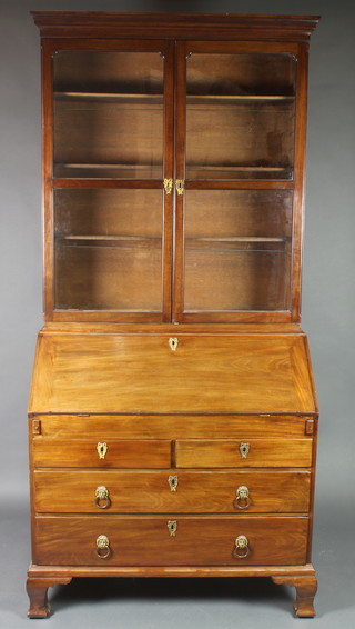 An 18th/19th Century mahogany bureau bookcase with moulded cornice, the associated  upper section fitted shelves enclosed by glazed panelled doors, the base with fall front revealing a well fitted interior above 2 short and 2 long drawers, raised on ogee bracket feet 90"h x 42"w x 22"d 