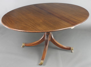 A William Tillman Georgian style oval mahogany extending dining table, raised on a turned tripod base with brass caps and castors 29"h x 45"w x 59" when closed x 76" with extra leaf 