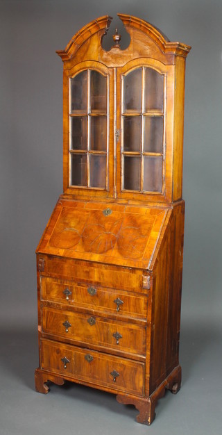 A Queen Anne style figured walnut and crossbanded bureau bookcase, the upper section with broken pediment, fitted adjustable shelves enclosed by astragal glazed panelled doors, the fall front revealing a stepped interior with well above 3 long drawers, raised on bracket feet 73"h x 24"w x 15"d 