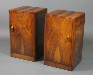 A pair of Art Deco walnut bedside cabinets enclosed by panelled doors 24 1/2"h x 15"w x 13 1/2"d