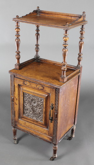 A Victorian oak 2 tier coal purdonium converted for use as a bedside cabinet, the upper section fitted a shelf above a cupboard enclosed by panelled doors, raised on turned supports 38"h x 15 1/2"w x 10 1/2"d 