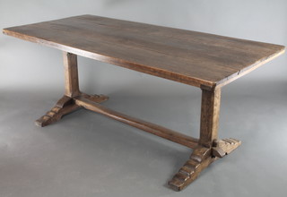 An oak refectory dining table with triple plank top, raised on square supports with H framed stretcher 28 1/2"h x 70"l x 32 1/2"w 