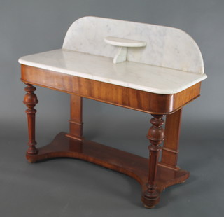 A Victorian mahogany Duchess washstand with raised marble back, raised on turned and fluted  supports with shaped under tier 34"h x 40 1/2"w x 19"d  
