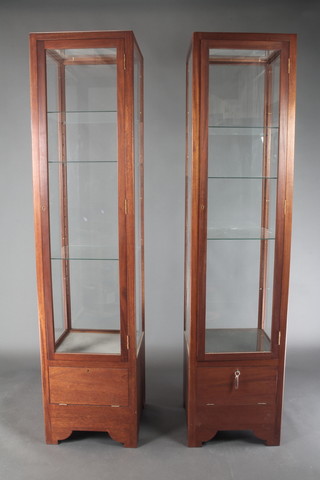 A pair of 20th Century rectangular mahogany pedestal shop display cabinets fitted shelves 76"h x 18"w x 18"d 