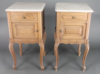 A pair of 19th Century French oak bedside cabinets with white veined marble tops fitted a drawer, raised on carved cabriole supports 34"h x 16"w x 16"d 