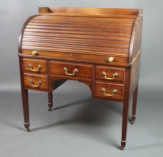 A Victorian mahogany cylinder bureau with three-quarter gallery and well fitted interior, above 1 long and 2 short drawers raised on square tapering supports ending in spade feet, brass caps and casters 44"h x 38"w x 22"d 