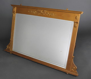 A 19th Century rectangular bevelled plate over mantel mirror contained in a gilt painted frame surmounted by a pair of crossed torches 30"h x 47"w x 2"d 
