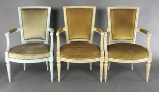 A set of 3 painted open arm salon chairs