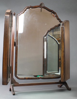 A Queen Anne style shaped triple plate dressing table mirror contained in a walnut frame surmounted by a shell 26" x 33" 